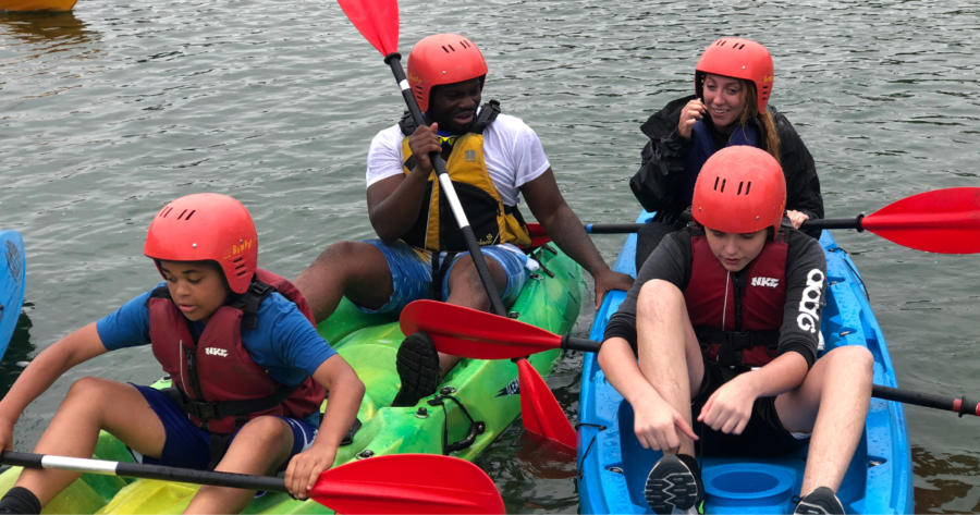 A group of young people canoing in Stoke on Trent - smiling and enjoying the fun.