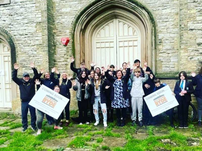 Young people waving and cheering outside the new home for the youth service, Network Ryde on the Isle of Wight