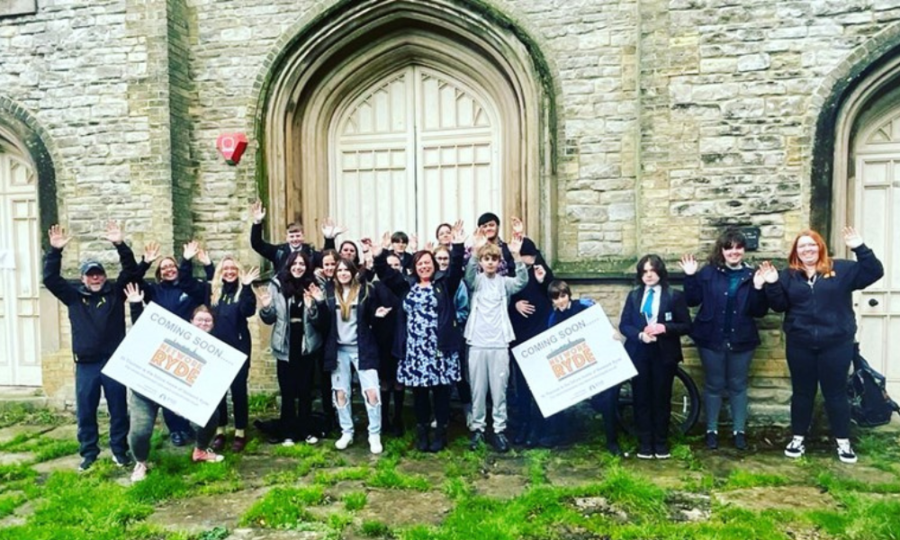 Young people waving and cheering outside the new home for the youth service, Network Ryde on the Isle of Wight