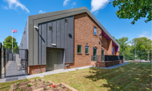 The new Sheffield High Green Scout Hut. View of the building, grass and flowerbeds