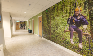 Inside view of the Scout Hut showing a spacious corridor with images of scouts on the walls.